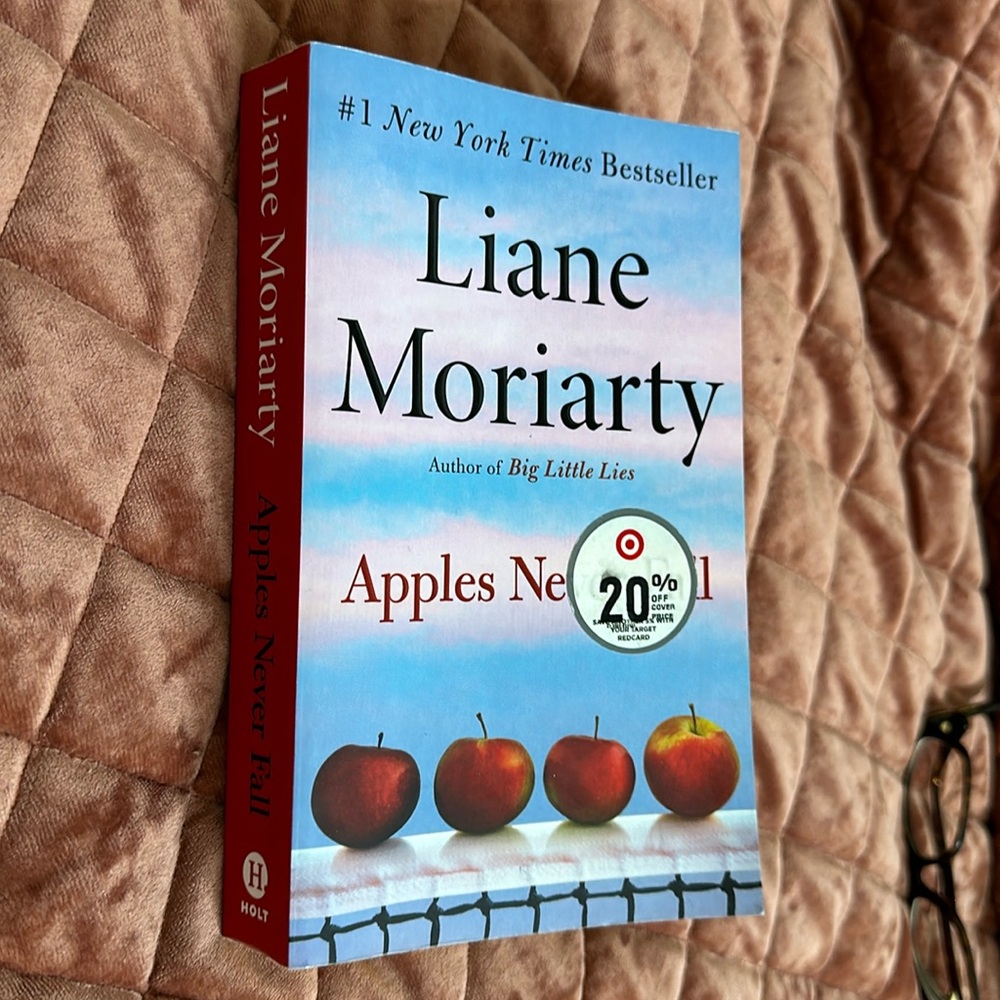 A paperback copy of Apples Never Fall by Liane Moriarty.